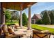 Inviting outdoor patio with comfortable seating and a view of the landscaped yard at 17800 Se 237Th Ct, Umatilla, FL 32784