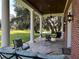 Relaxing outdoor patio with a ceiling fan, stone flooring, and views of the lush yard at 17800 Se 237Th Ct, Umatilla, FL 32784