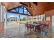 Beautiful poolside view of a home with manicured landscaping, a covered outdoor dining area, and a luxurious pool at 17800 Se 237Th Ct, Umatilla, FL 32784