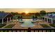 Aerial view of a large pool with spas and well-manicured lawns at sunset at 17800 Se 237Th Ct, Umatilla, FL 32784