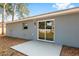 Sliding glass doors open to a concrete patio in the backyard of the house at 13374 Sw 112 St, Dunnellon, FL 34432