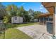 Large backyard with two sheds and patio area at 21406 Sw Plantation St, Dunnellon, FL 34431