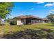 House exterior showcasing backyard and screened porch at 21406 Sw Plantation St, Dunnellon, FL 34431