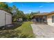 View of backyard, sheds and screened porch at 21406 Sw Plantation St, Dunnellon, FL 34431