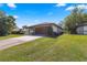 House exterior with attached garage and driveway at 21406 Sw Plantation St, Dunnellon, FL 34431