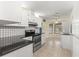 View of kitchen with stainless steel range and granite counters at 21406 Sw Plantation St, Dunnellon, FL 34431