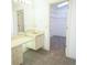 Bathroom vanity with a walk-in closet and carpeted floor at 4215 Se 24Th Ter, Ocala, FL 34480