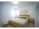 Comfortable bedroom with natural wood accents, dual windows, and a view of the outdoors at 4215 Se 24Th Ter, Ocala, FL 34480