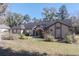 Tan house with a dark roof and landscaping at 4215 Se 24Th Ter, Ocala, FL 34480