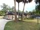 Well-maintained single story home with a beautiful lawn, mature trees, and an inviting concrete driveway at 4215 Se 24Th Ter, Ocala, FL 34480
