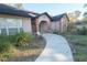 House exterior with a curved walkway to the entrance at 4215 Se 24Th Ter, Ocala, FL 34480