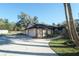 Home's exterior showcasing a two-car garage and walkway at 4215 Se 24Th Ter, Ocala, FL 34480