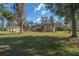 Inviting exterior view with mature trees, landscaping, and a well-maintained lawn at 4215 Se 24Th Ter, Ocala, FL 34480