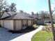 Exterior view of home with attached garage, sidewalk, and mature landscaping at 4215 Se 24Th Ter, Ocala, FL 34480