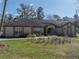 Charming single-story home featuring a well-manicured lawn, inviting entryway, and attractive landscaping at 4215 Se 24Th Ter, Ocala, FL 34480