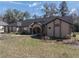 Inviting single-story home with a well-kept front lawn, arched entryway, and unique architectural details at 4215 Se 24Th Ter, Ocala, FL 34480