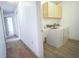 Functional laundry room with white washer and dryer, utility sink, and overhead cabinetry at 4215 Se 24Th Ter, Ocala, FL 34480