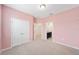 Pink bedroom with ensuite bathroom and double doors leading to a closet at 4737 Se 36Th St, Ocala, FL 34480