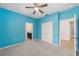 Blue bedroom with ceiling fan and double door closet at 4737 Se 36Th St, Ocala, FL 34480