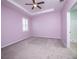 Lavender bedroom with a window, carpet, and ensuite bathroom at 4737 Se 36Th St, Ocala, FL 34480