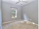 Bright bedroom with gray walls, carpet flooring, and a ceiling fan at 2935 Ne 7Th St # 102, Ocala, FL 34470