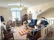 Upstairs living area with ceiling fan, bright windows, blue furniture, and carpet at 3403 Gatlin Place Cir, Orlando, FL 32812