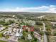 Aerial view of property with a red boundary in a neighborhood near a scenic waterway and dense forest at 34828 1St Ave, Leesburg, FL 34788