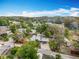 Aerial view of property in a neighborhood, showing its location with surrounding mature trees at 34828 1St Ave, Leesburg, FL 34788