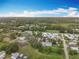 An aerial view showcases a neighborhood with green spaces, various home styles, and community layout at 34828 1St Ave, Leesburg, FL 34788
