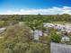 Aerial view of the property surrounded by lush trees in an established neighborhood at 34828 1St Ave, Leesburg, FL 34788