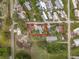 An aerial view highlights the property lines of a home and its surrounding land in a residential area at 34828 1St Ave, Leesburg, FL 34788