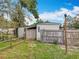 Backyard view shows a fenced-in yard with mature trees and a storage shed at 34828 1St Ave, Leesburg, FL 34788