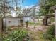 View of the backyard showcasing a storage shed, picnic table and green space at 34828 1St Ave, Leesburg, FL 34788