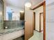Bathroom featuring a dark green tile countertop and flooring and adjacent shower at 34828 1St Ave, Leesburg, FL 34788