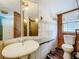 Traditional bathroom offers a pedestal sink and tiled shower and walls at 34828 1St Ave, Leesburg, FL 34788