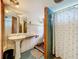 Full bathroom with a pedestal sink, shower and unique tile accents at 34828 1St Ave, Leesburg, FL 34788