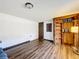 Neutral bedroom with hardwood floors and closet organizers at 34828 1St Ave, Leesburg, FL 34788