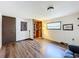 Bright bedroom features wood floors, closet with wooden organizers, and AC unit at 34828 1St Ave, Leesburg, FL 34788