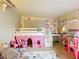 Playful bedroom featuring loft bed, vanity, and colorful decor at 34828 1St Ave, Leesburg, FL 34788