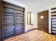 Interior hallway with laminate floors, built in shelving, and visible closet and doorway entrances at 34828 1St Ave, Leesburg, FL 34788