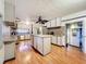 Spacious kitchen with a center island, stainless steel appliances, and wood-look flooring at 34828 1St Ave, Leesburg, FL 34788