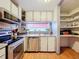 Efficient kitchen features stainless appliances, tile backsplash, and extra storage shelving at 34828 1St Ave, Leesburg, FL 34788