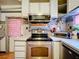 Functional kitchen shows stainless oven, microwave, and tile backsplash at 34828 1St Ave, Leesburg, FL 34788