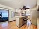 Bright kitchen with island, light cabinets, wooden floors, and adjacent living area at 34828 1St Ave, Leesburg, FL 34788
