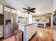 Bright kitchen with an island, stainless steel appliances, white cabinets, and wood-look flooring at 34828 1St Ave, Leesburg, FL 34788