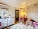 Playroom with neutral walls, teddy bears, and a colorful play mat on tile floor at 34828 1St Ave, Leesburg, FL 34788