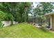 Spacious backyard featuring a screened pool area and lush green lawn at 4893 Sw 4Th Cir, Ocala, FL 34471