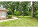 The backyard features a sidewalk and a well-manicured lawn with trees, providing a tranquil retreat at 4893 Sw 4Th Cir, Ocala, FL 34471
