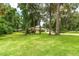This expansive backyard offers plenty of room to roam, with mature trees and a lush green lawn at 4893 Sw 4Th Cir, Ocala, FL 34471