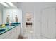 Bathroom featuring a double vanity, a large mirror, and a doorway to a bedroom at 4893 Sw 4Th Cir, Ocala, FL 34471